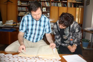 The Lutheran pastor and our translator, Lubica, pore over the old church records.